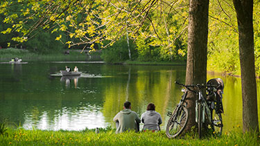 People watching boats on a tranquil lake