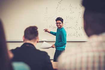 Student presenting at a whiteboard