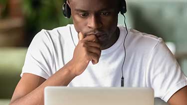 Student studying at his laptop