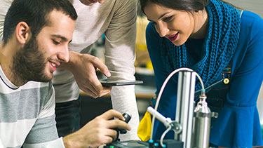 Students working on a robot in a lab