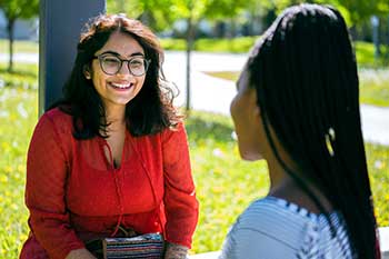 Students sitting outdoors on the University of Manitoba campus