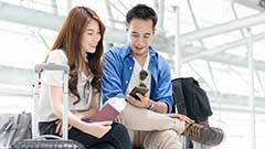 Students waiting in an airport with their luggage