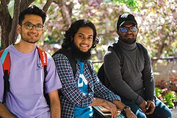 Students sitting on a bench outdoors