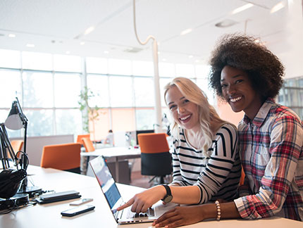 Students smiling while working indoors