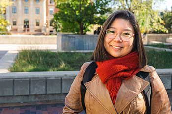 Student smiling outdoors on the University of Manitoba campus