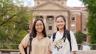 Students smiling outdoors on the University of Manitoba campus