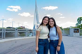 Students standing at the foot of a bridge in Winnipeg