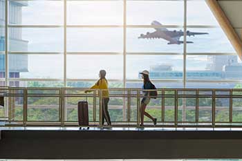 Students walking across a bridge in an airport