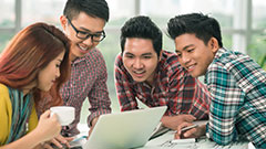 Students working at a laptop indoors