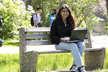 Smiling student working on laptop