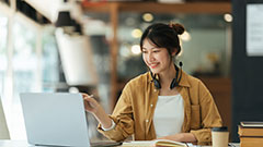 Student working in a cafe on a laptop