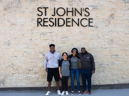4 students from St John's Residence standing together