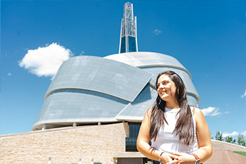 A female student in front of the Museum of Human Rights