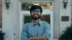 A photo of Sudipta Dip standing i front of a building